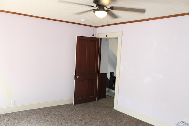 carpeted spare room featuring ceiling fan and ornamental molding