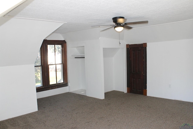 additional living space featuring carpet flooring, ceiling fan, a textured ceiling, and vaulted ceiling