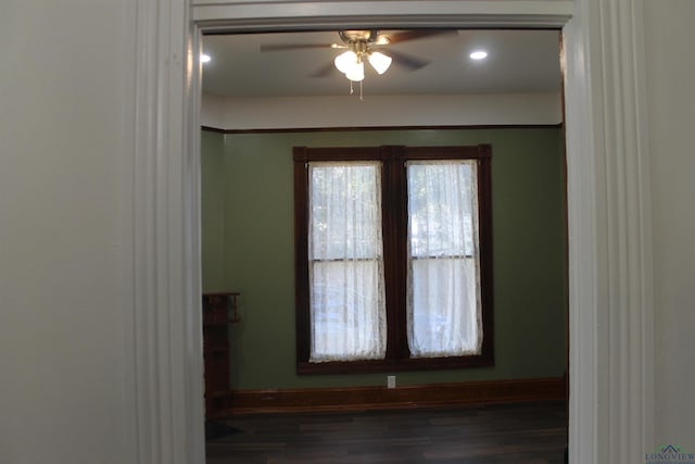 unfurnished room with ceiling fan and dark hardwood / wood-style floors