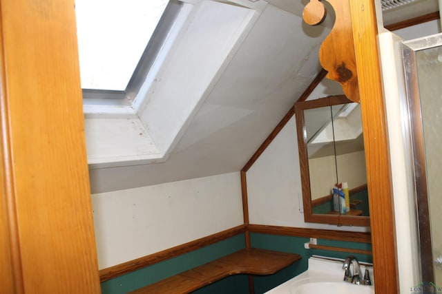 bathroom featuring vanity and a skylight