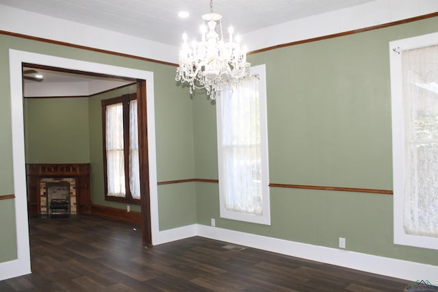 unfurnished dining area featuring dark hardwood / wood-style flooring and an inviting chandelier