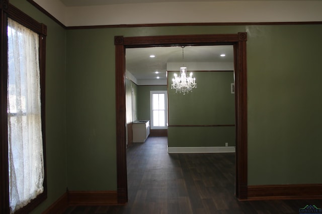 interior space featuring dark hardwood / wood-style floors and an inviting chandelier