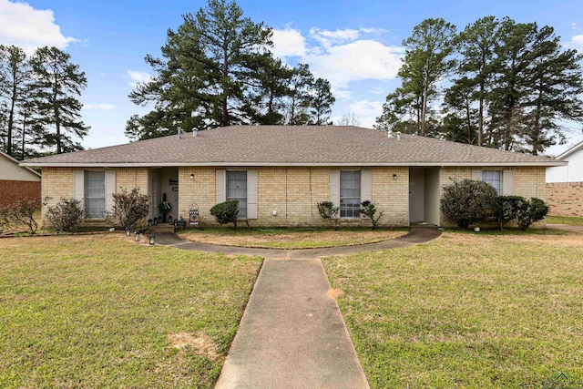 ranch-style house with brick siding and a front yard