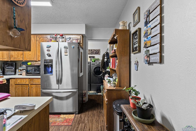 kitchen with brown cabinetry, dark wood finished floors, light countertops, black microwave, and stainless steel fridge