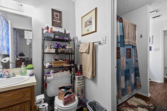 bathroom featuring vanity, a shower with curtain, wood finished floors, baseboards, and a textured ceiling