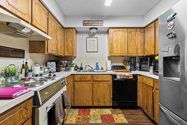 kitchen featuring light countertops, stainless steel refrigerator with ice dispenser, under cabinet range hood, a textured ceiling, and dishwasher