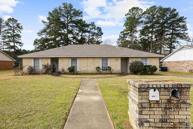 ranch-style home featuring a front lawn, brick siding, and a shingled roof