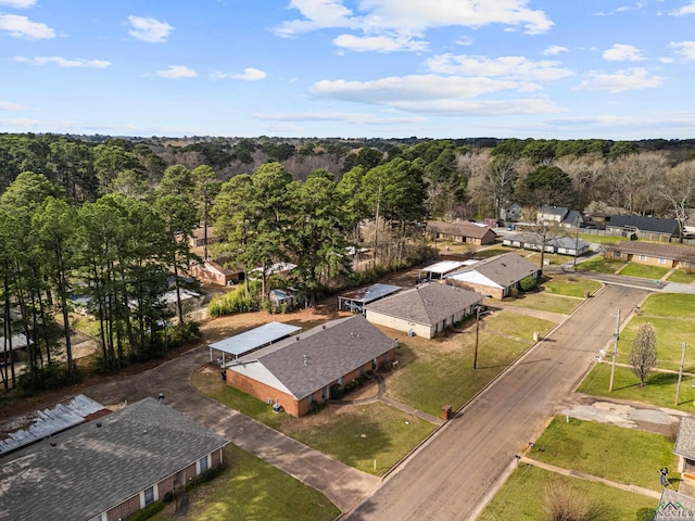 drone / aerial view with a wooded view