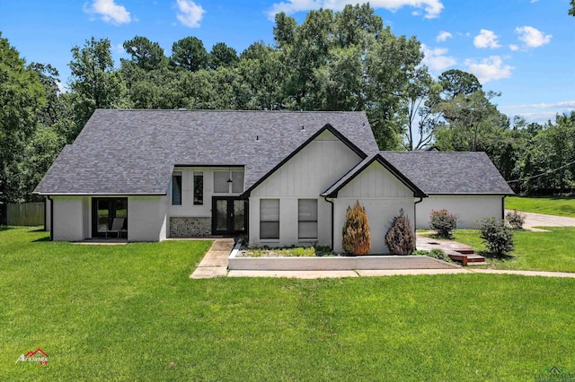 view of front facade with french doors and a front lawn