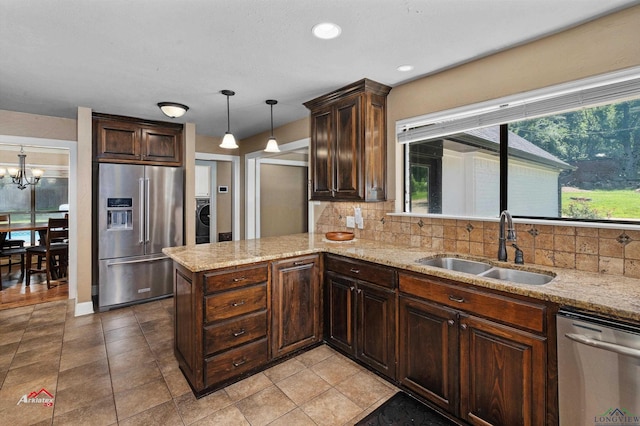 kitchen with sink, hanging light fixtures, backsplash, kitchen peninsula, and appliances with stainless steel finishes