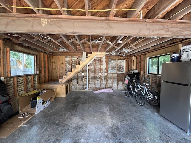 basement with stainless steel refrigerator