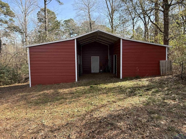 view of outbuilding with a yard