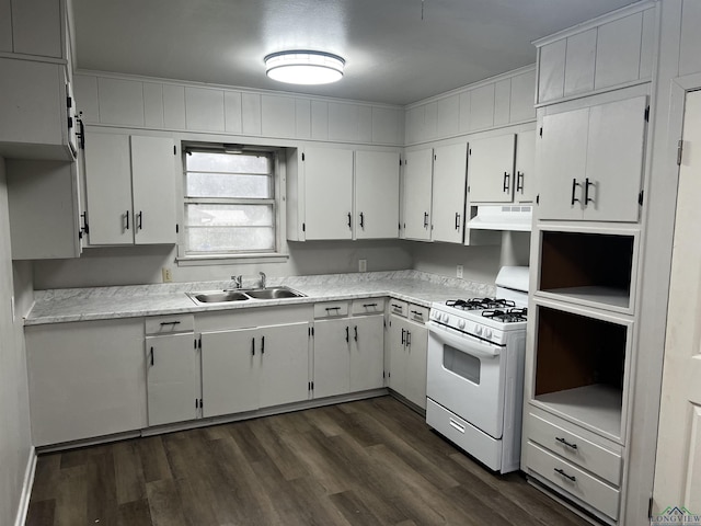 kitchen with white cabinetry, white gas range, and sink