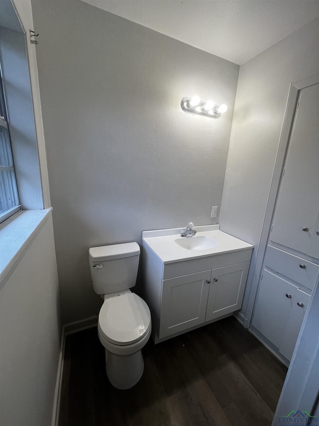 bathroom featuring hardwood / wood-style floors, vanity, and toilet