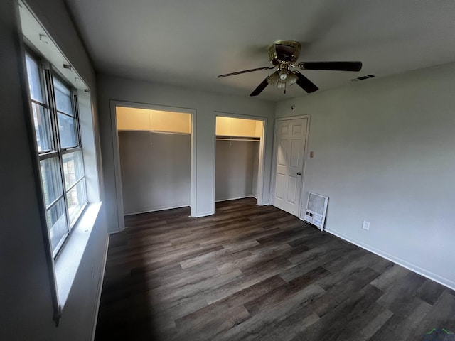 unfurnished bedroom featuring ceiling fan and dark wood-type flooring