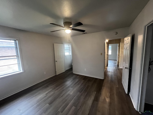 unfurnished bedroom featuring dark hardwood / wood-style flooring and ceiling fan