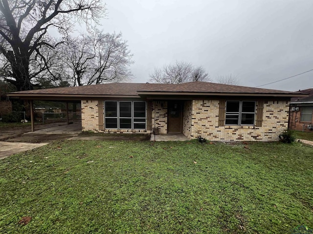 view of front of house with a front yard and a carport