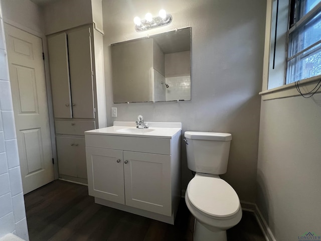 bathroom featuring wood-type flooring, vanity, and toilet