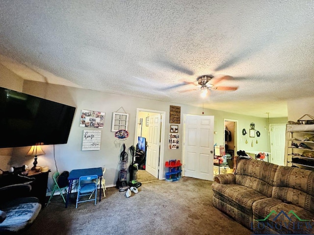 carpeted living room featuring ceiling fan and a textured ceiling