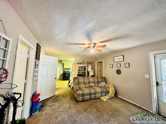 carpeted living room with ceiling fan and a textured ceiling