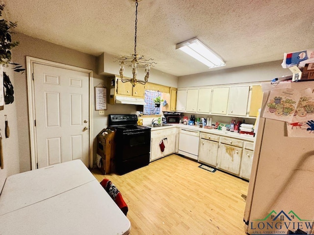 kitchen featuring a textured ceiling, white appliances, sink, decorative light fixtures, and light hardwood / wood-style flooring