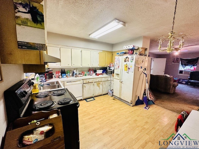 kitchen featuring a chandelier, a textured ceiling, pendant lighting, white appliances, and light hardwood / wood-style floors