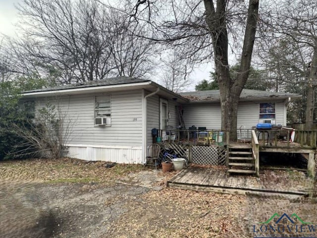 back of property with a deck and cooling unit