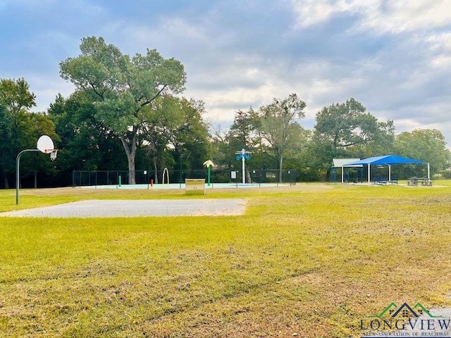 view of home's community with a yard and basketball court