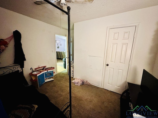 carpeted bedroom featuring a textured ceiling