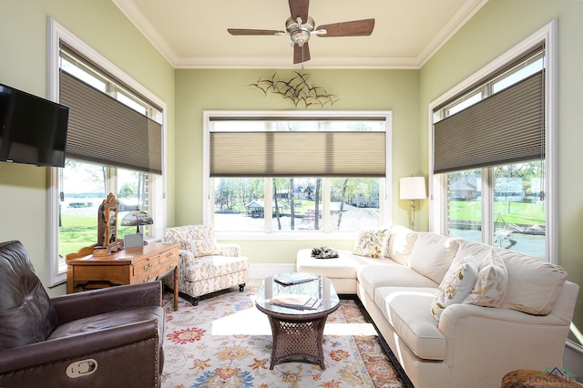 living room with ornamental molding and ceiling fan