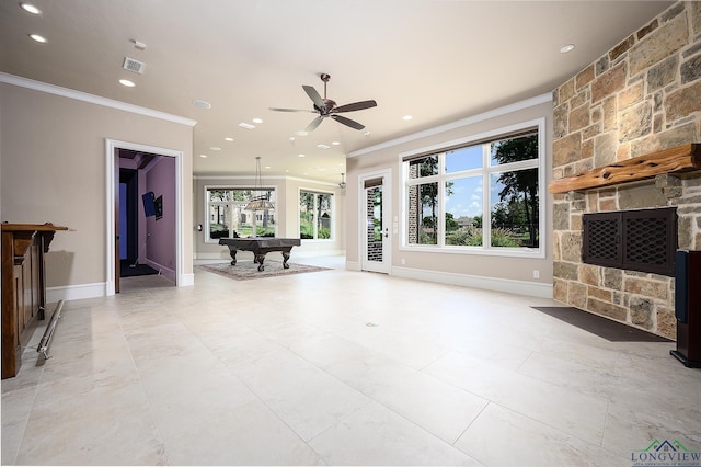 unfurnished living room with crown molding, billiards, a stone fireplace, and ceiling fan