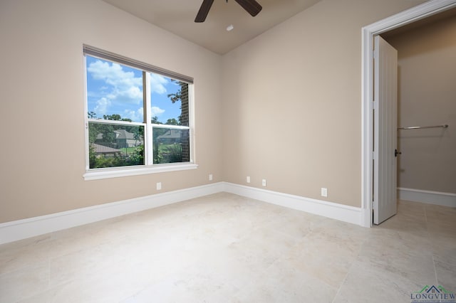 unfurnished room with ceiling fan and vaulted ceiling