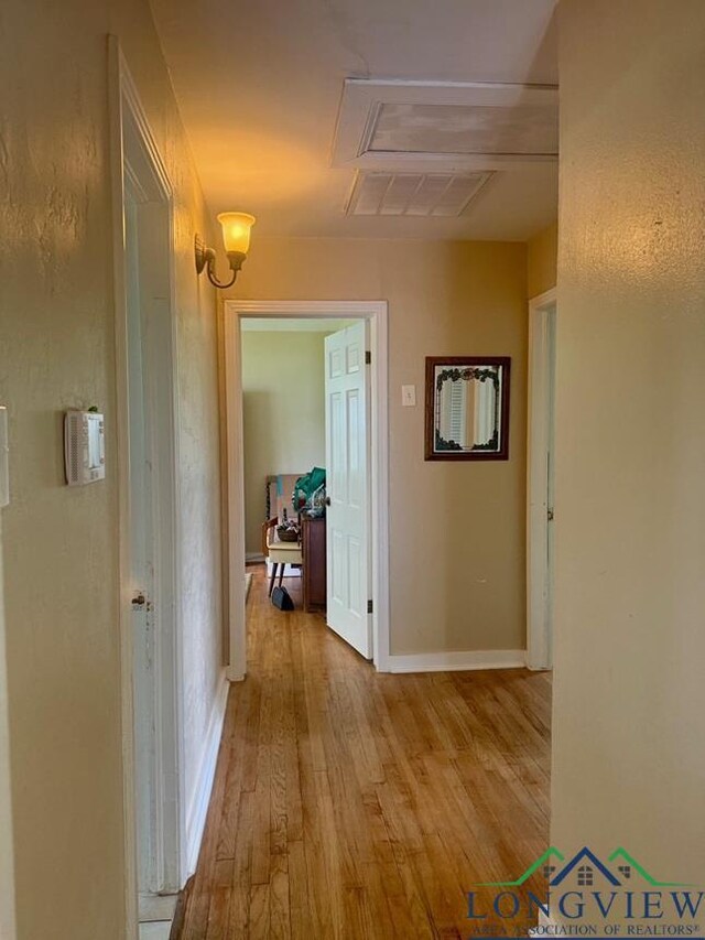 115 Bryant St, Longview, TX 75605 - corridor with attic access, wood-type flooring, and baseboards