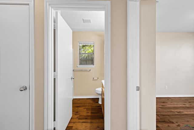 bathroom with vanity, hardwood / wood-style flooring, and toilet