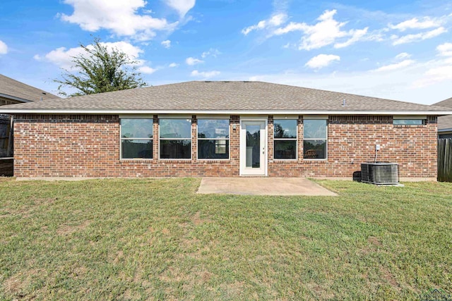 rear view of house featuring central air condition unit, a yard, and a patio