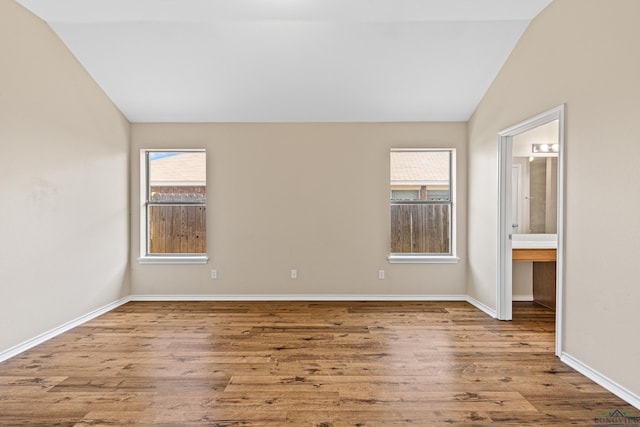 interior space with vaulted ceiling and light hardwood / wood-style flooring