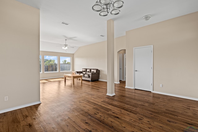 living room featuring ceiling fan with notable chandelier, dark hardwood / wood-style flooring, and vaulted ceiling