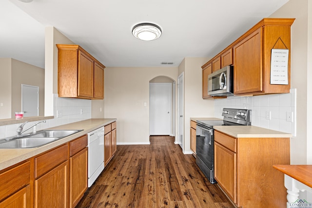 kitchen with electric range, dishwasher, sink, dark hardwood / wood-style flooring, and decorative backsplash