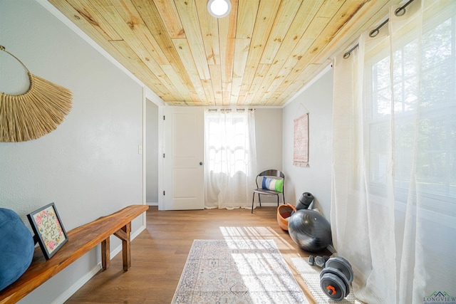 unfurnished room featuring crown molding, wooden ceiling, and wood-type flooring