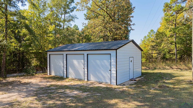 view of outbuilding featuring a garage and a yard