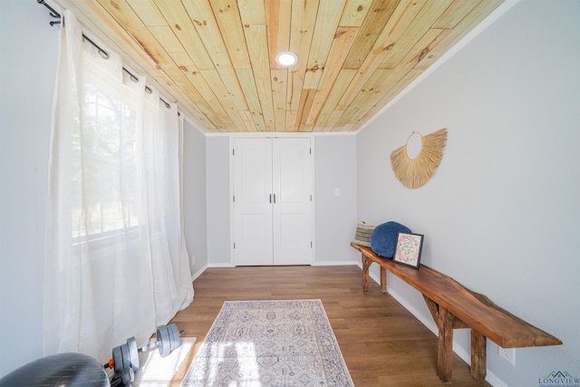 interior space with hardwood / wood-style flooring, wood ceiling, and crown molding