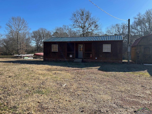 exterior space with a storage unit and a lawn