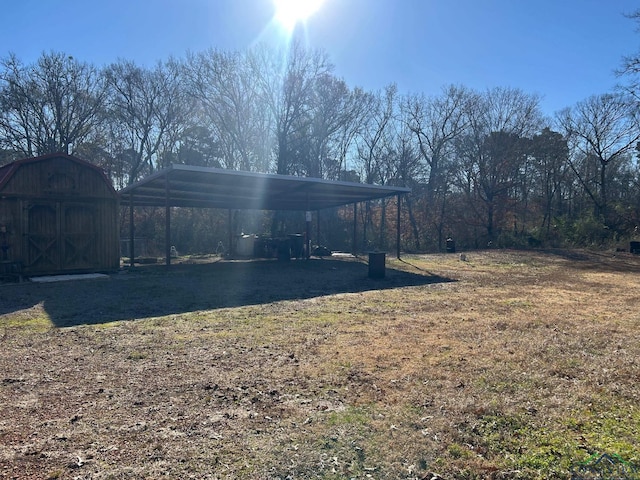 view of yard featuring a carport and a shed