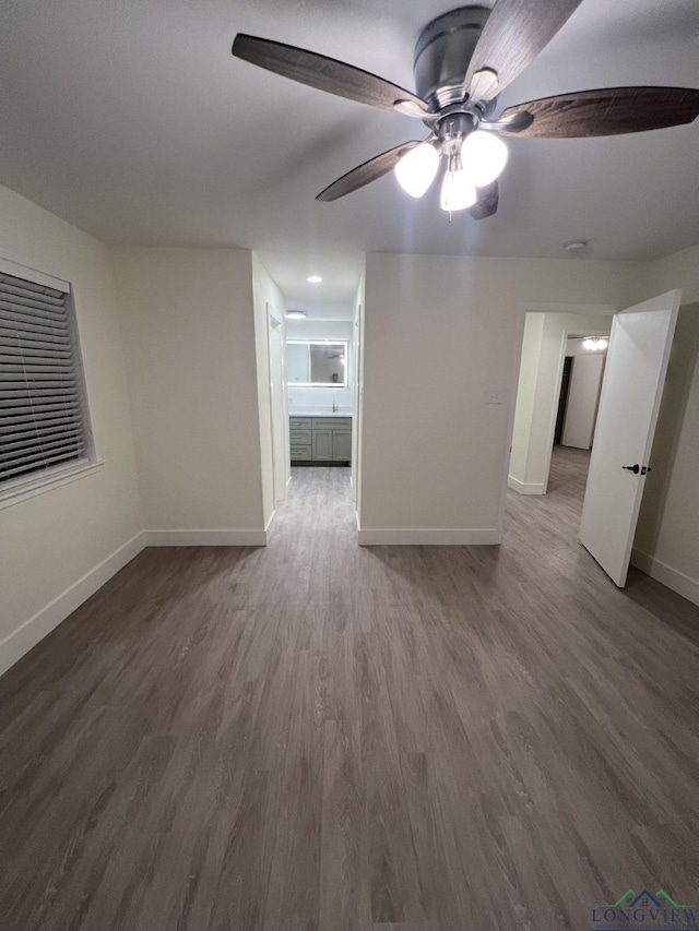 empty room with baseboards and wood finished floors