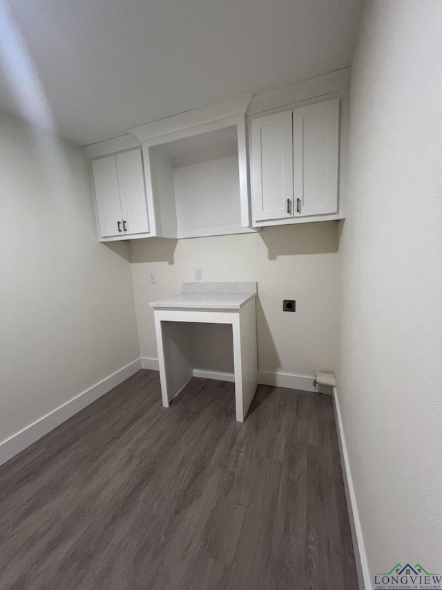 washroom featuring baseboards, dark wood finished floors, cabinet space, and hookup for an electric dryer