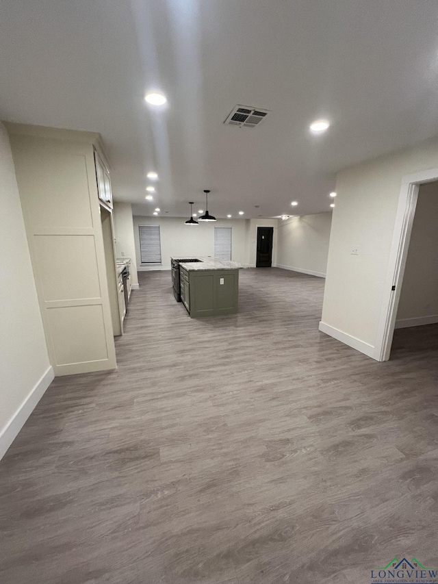 kitchen with light countertops, open floor plan, visible vents, and wood finished floors