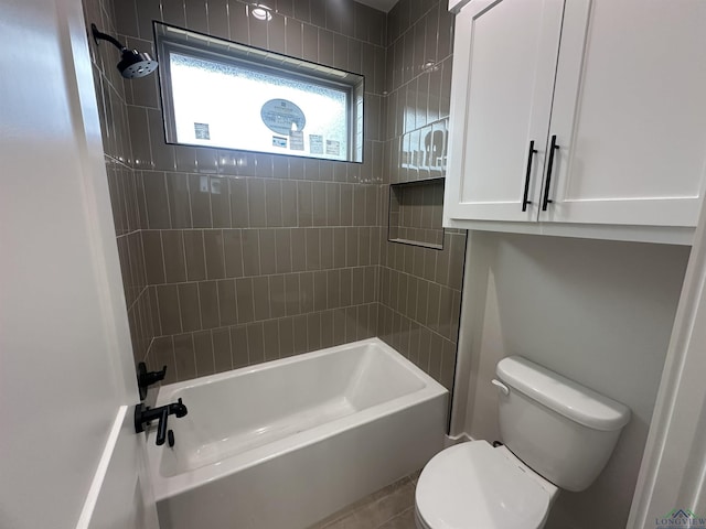 bathroom featuring shower / bath combination and toilet