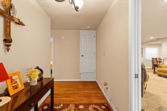 hall with wood-type flooring