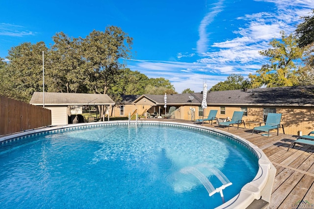 view of swimming pool featuring a wooden deck