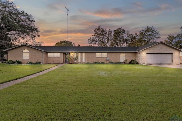 ranch-style house with a lawn and a garage